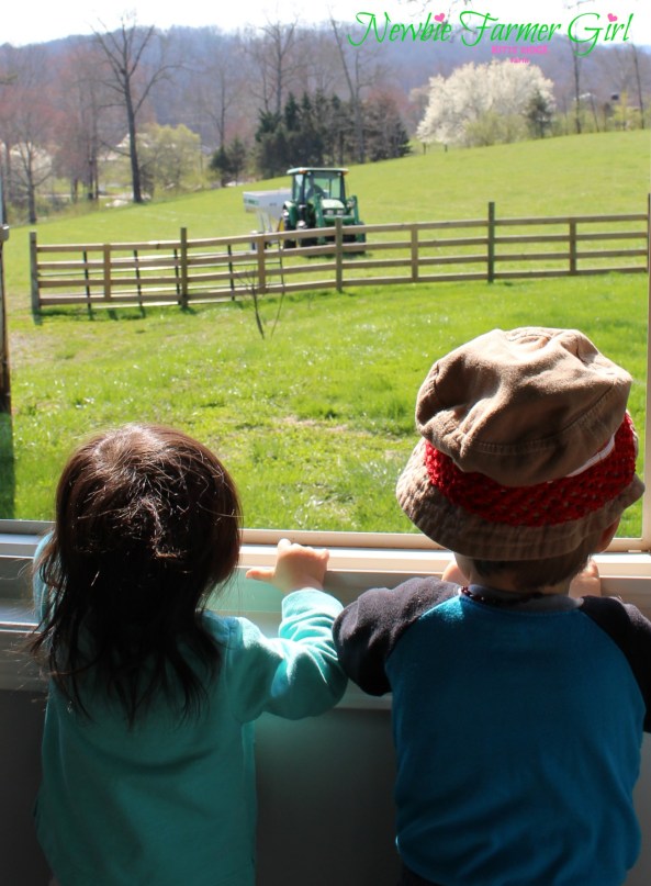 Kye and Kensi looking out window at daddy on tractor